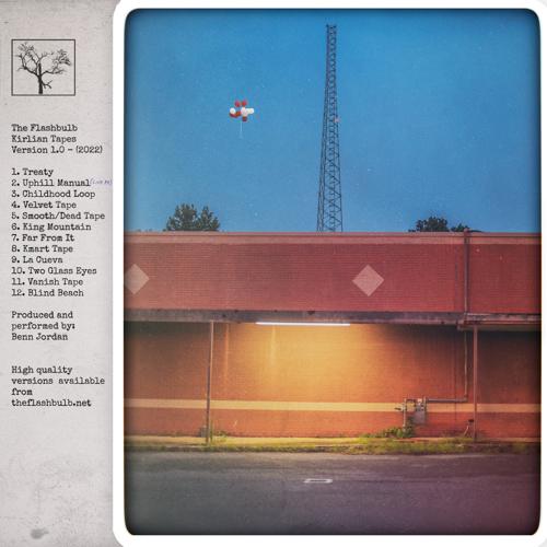 Album art: Kirlian Tapes v1​.​0. A photo of a radio station at dawn or possibly dusk. A light under the awning provides warm illumination. The radio tower rises along the center of the photo; in the distance, to the left, a bundle of red and white balloons floats gently away.