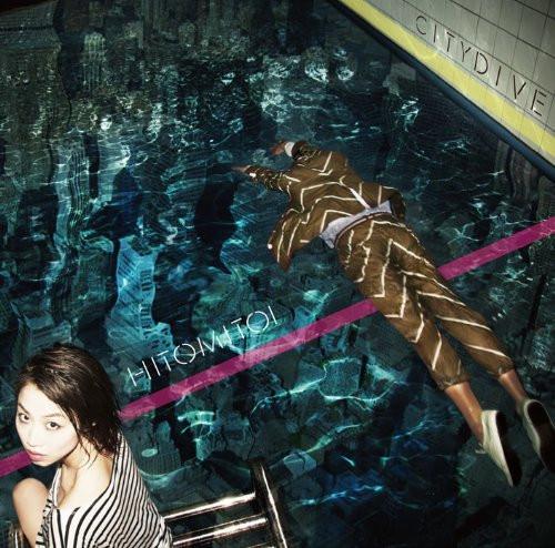 Album cover. A photograph of a person swimming in a pool and another person looking at the camera. Neither are wearing swimwear; they appear to be dressed casually. Along the water is the text HITOMITOI, and engraved into the tiles next to the pool is the text CITY DIVE.